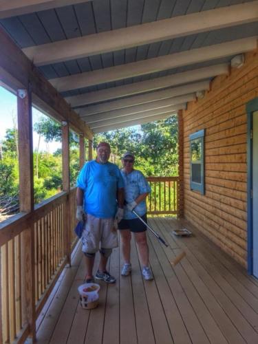Joe and Susan painting Nature Center porch